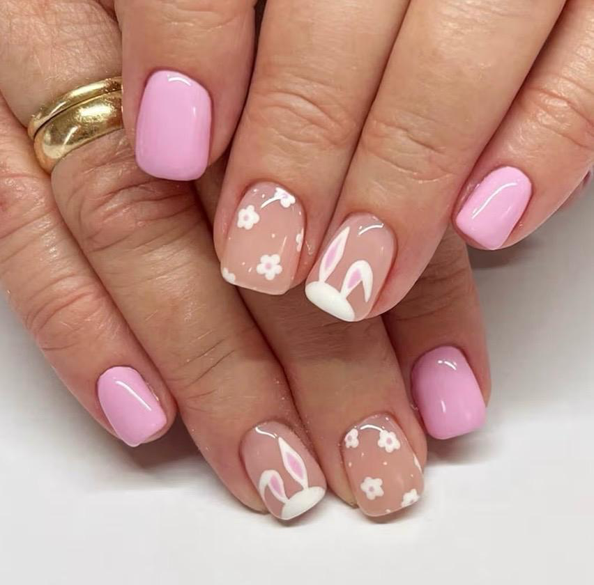 Soft pink nails with white bunny ears and daisy flowers
